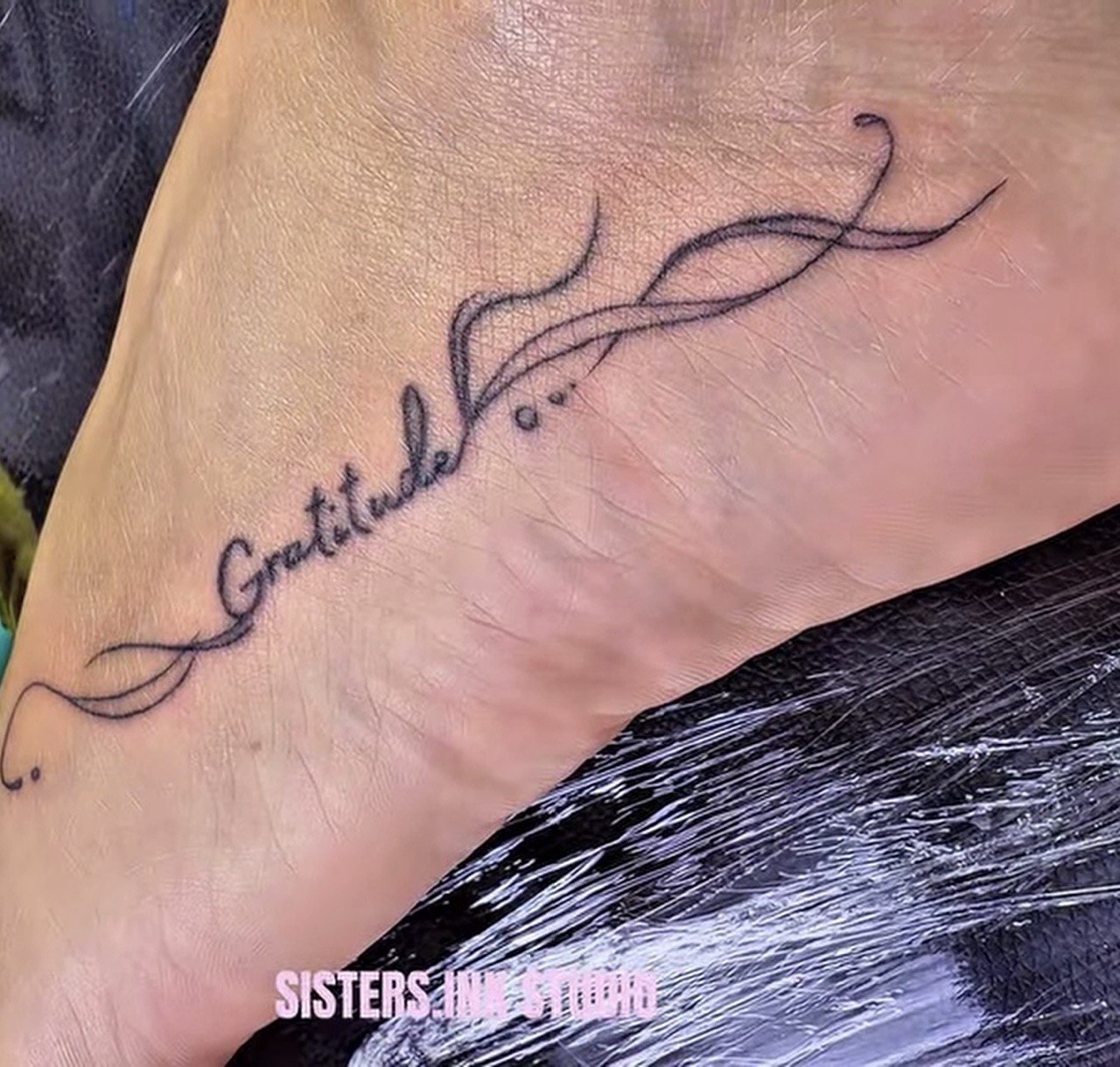 Fine-line Gratitude script tattoo on foot - Sisters Ink Tattoo Studio Da Nang